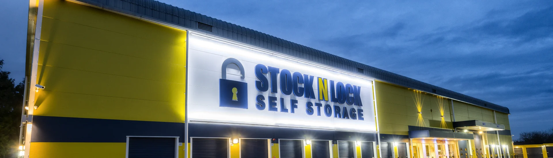 The exterior of a Stock N Lock self storage near me building at night