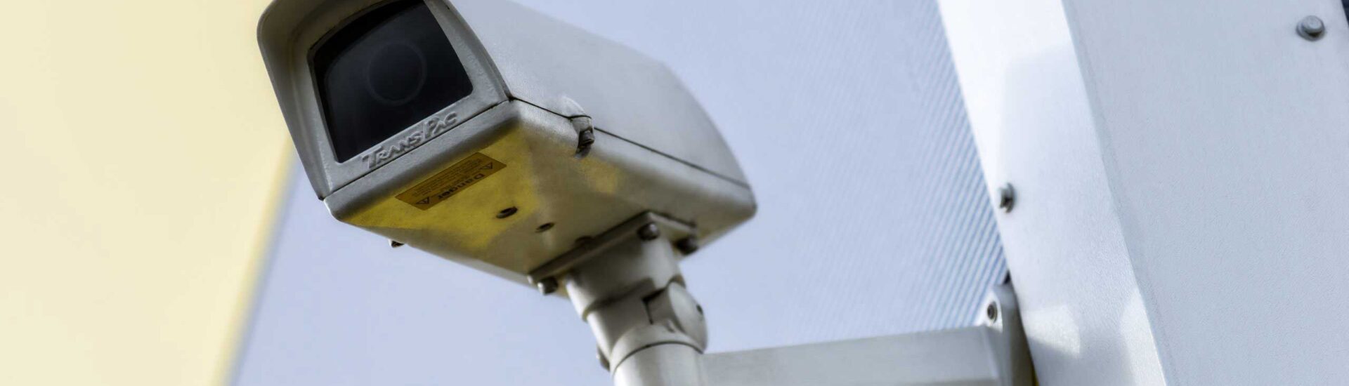 Close-up of a mounted security camera on an exterior wall