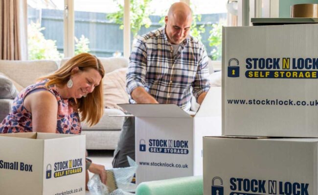 Couple packing moving boxes from Stock N Lock Self Storage at home