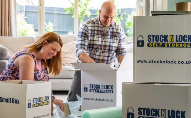 Couple packing moving boxes from Stock N Lock Self Storage at home
