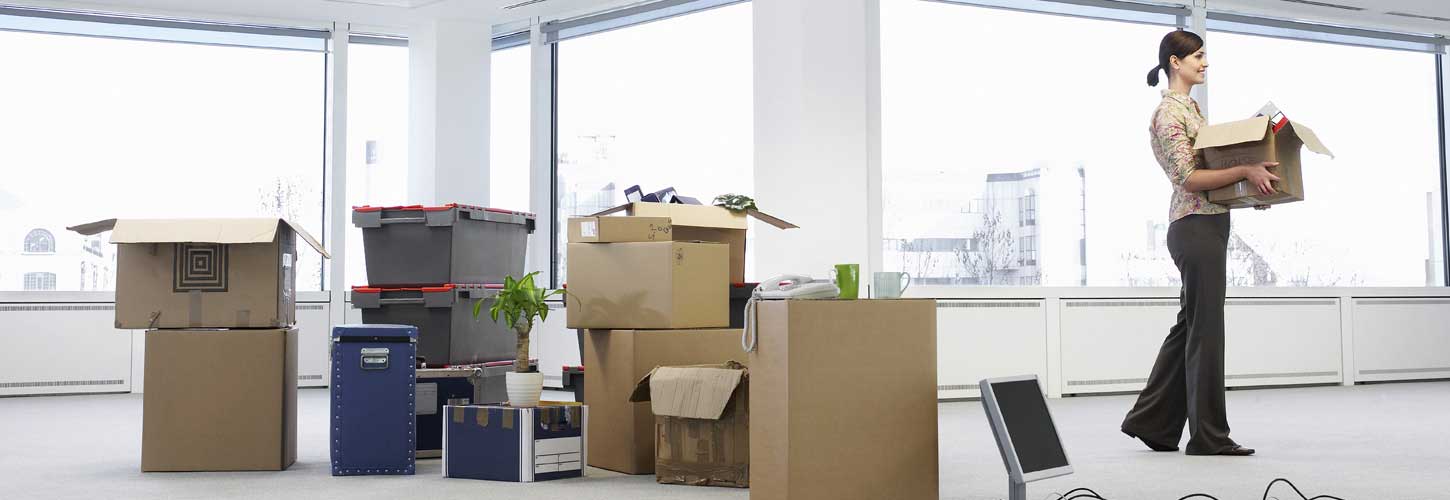 Businesswoman moving boxes during office relocation