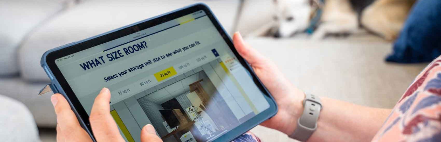 Person using a tablet to calculate storage room size at home