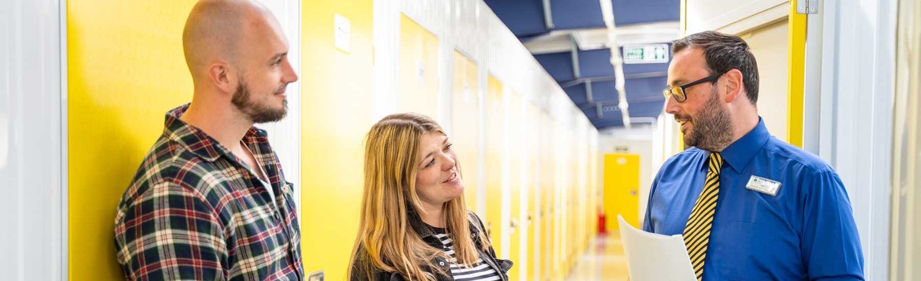 Customer couple receiving self-storage advice from Stock N Lock staff member